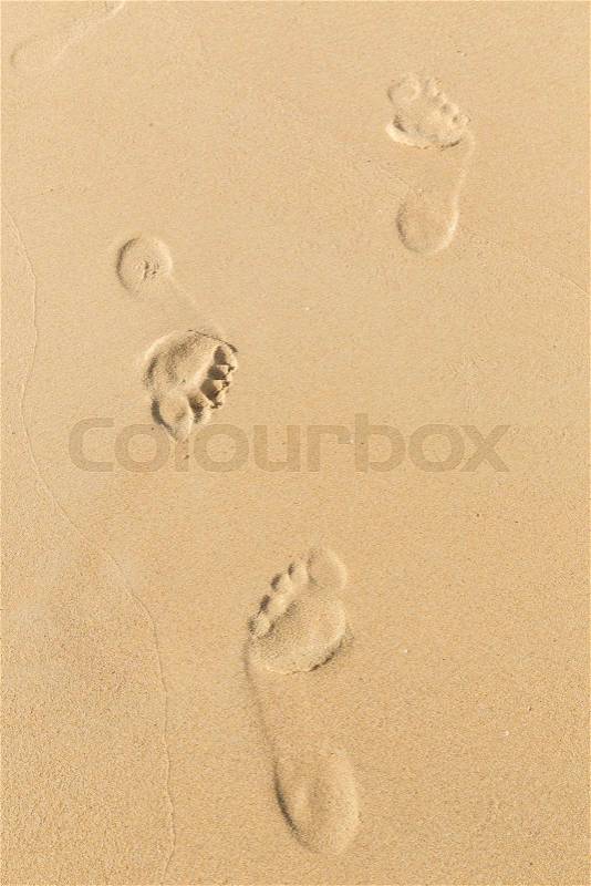 Foot prints on sand at the beach in the afternoon, Phuket, Thailand, stock photo