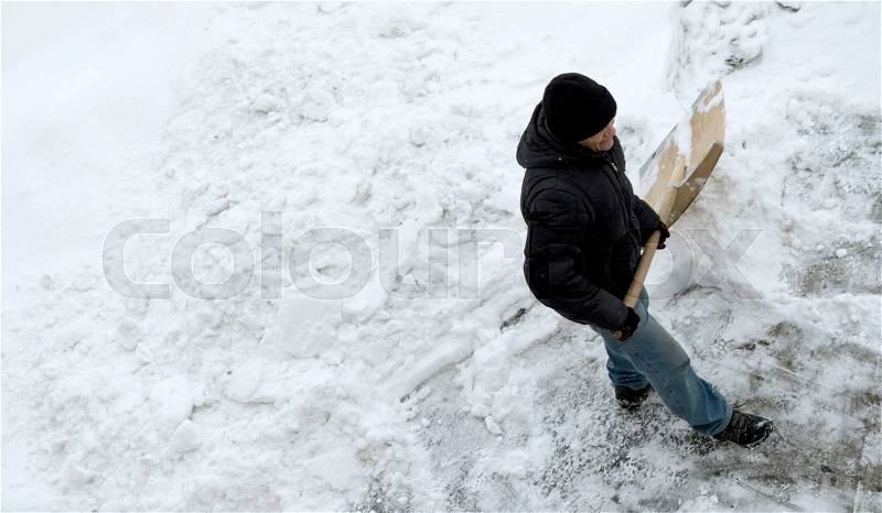 Man cleans snow, top view, stock photo