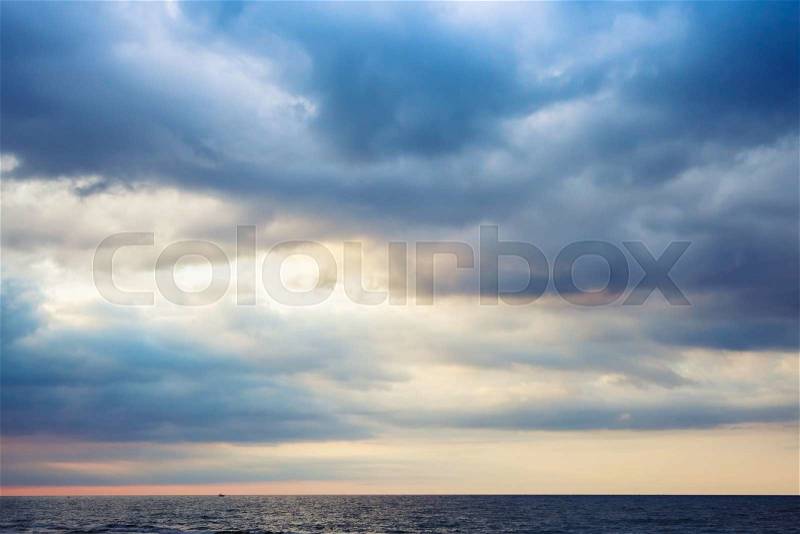 Dramatic morning seascape, colorful cloudy sky over horizon, stock photo