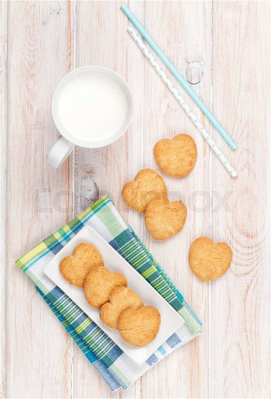  image of 'Cup of milk and heart shaped cookies on white wooden table