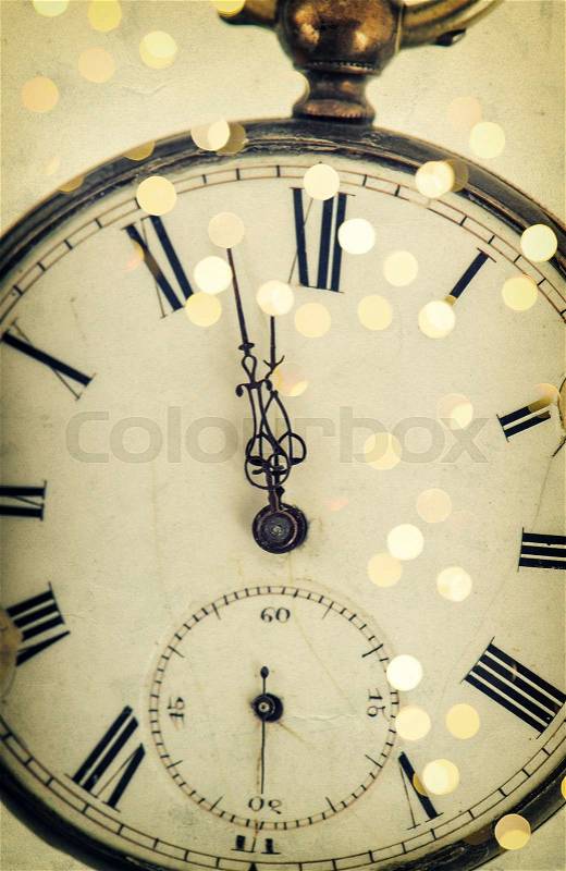 Five to twelve. Clock face and party lights decoration. Vintage style toned picture, stock photo