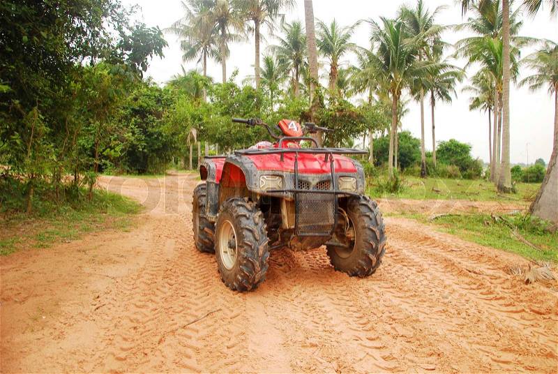 Quad bike on a road in jungle, stock photo