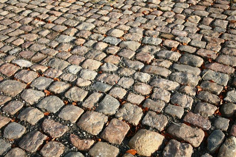 Not created abstractions, curves, lines, patterns; cobble stones street in the sun, stock photo