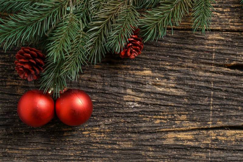 Still life of christmas ornament and tree branch on wooden board, stock photo