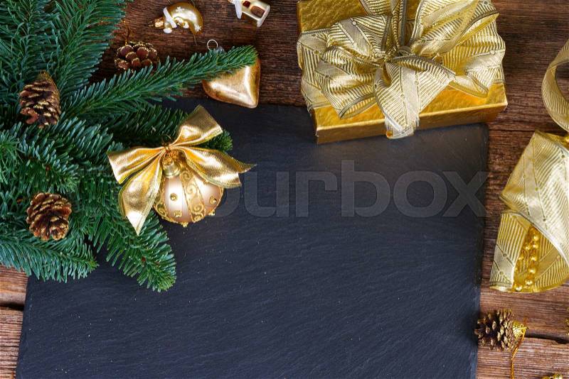 Fresh evergreen tree with golden decorations christmas frame on black background, stock photo