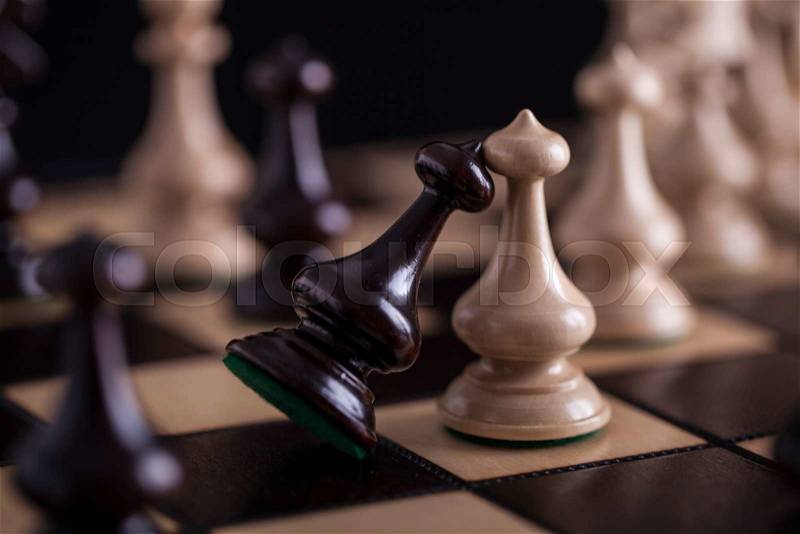 Chess. White pawns vs black on wooden chessboard, stock photo