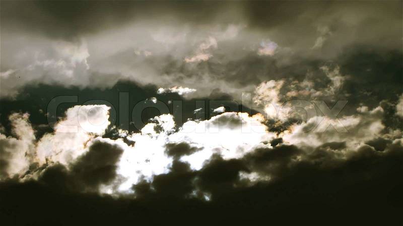 Mystical dark sky with clouds and sun, stock photo