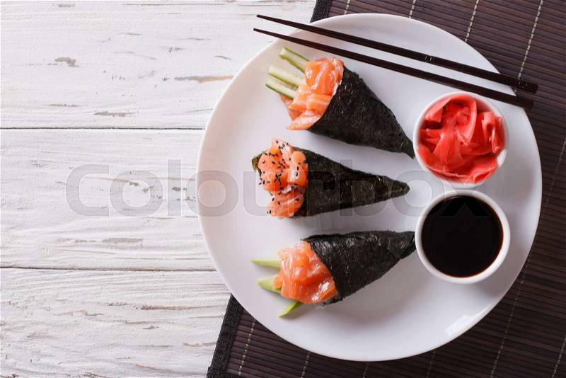 Japanese food: Salmon temaki sushi, pickled ginger and sauce. horizontal view from above , stock photo