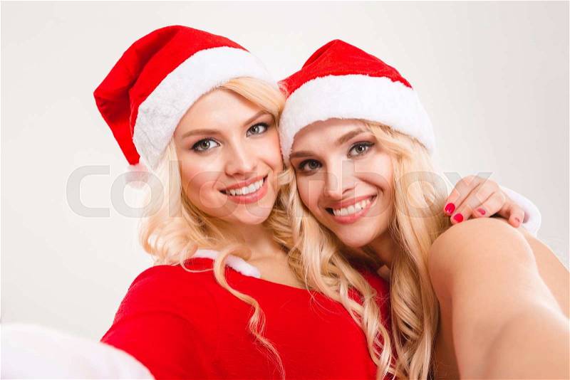 Selfie portrait of two lovely charming blonde sisters twins, stock photo