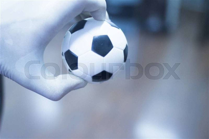 Wrist finger hand strength physiotherapy ball being held and compressed in sports injury physiotherapist medical center, stock photo