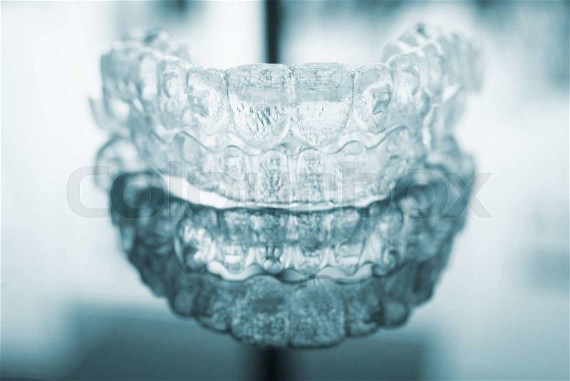 Invisible dental teeth brackets tooth aligners plastic braces dentistry retainers to straighten teeth. Orthodontic temporary removable straighteners in dentist office dental surgery clinic. , stock photo