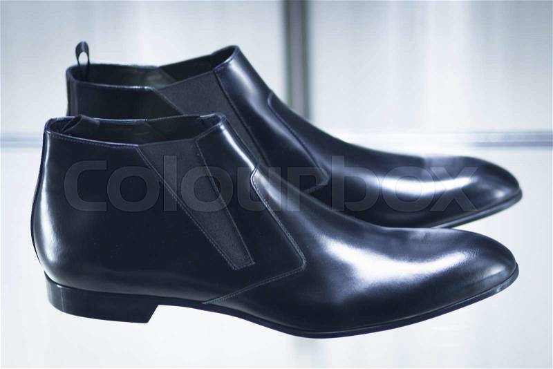 Shop window fashion store designer luxury leather shiny polished shoes, stock photo