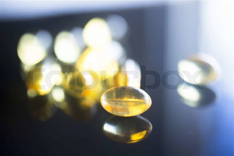 Cod liver fish oil omega 3, 6 and 9 capsules health food supplements, stock photo