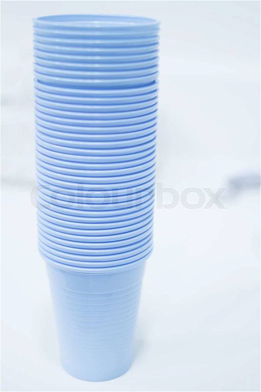 Dentist\'s water rinse cups in dental clinic in artistic blue purple white tones. , stock photo