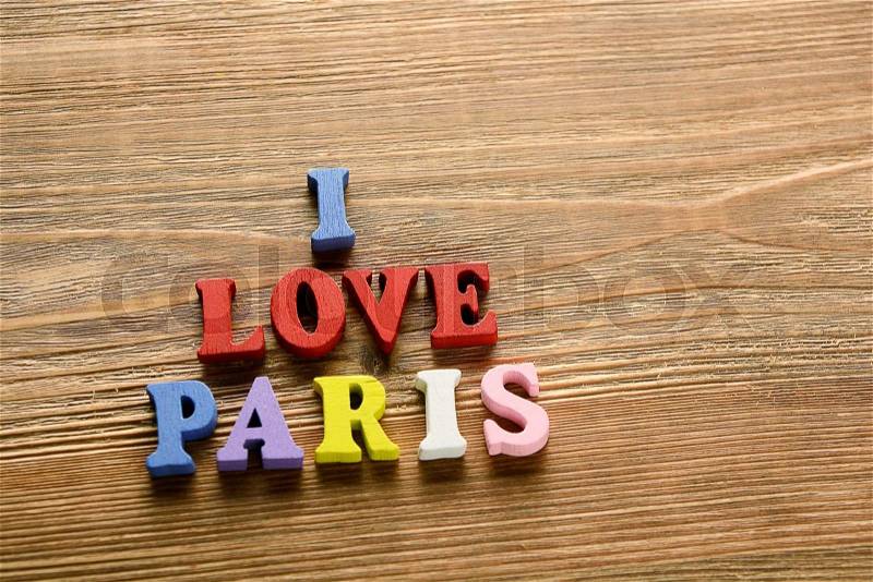 I LOVE PARIS - words made from multicolored letters on wooden background warm color, stock photo