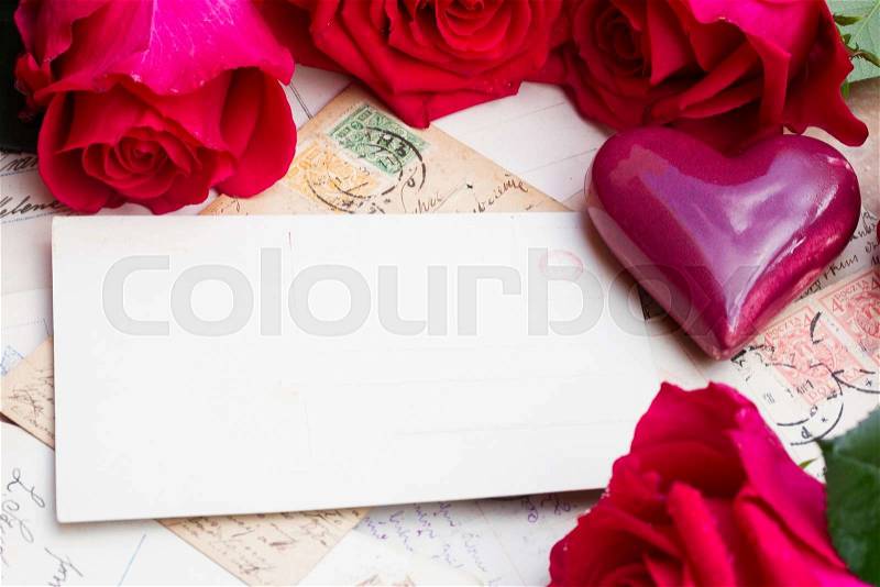 Empty postcard with vintage mail, heart and fresh roses, stock photo