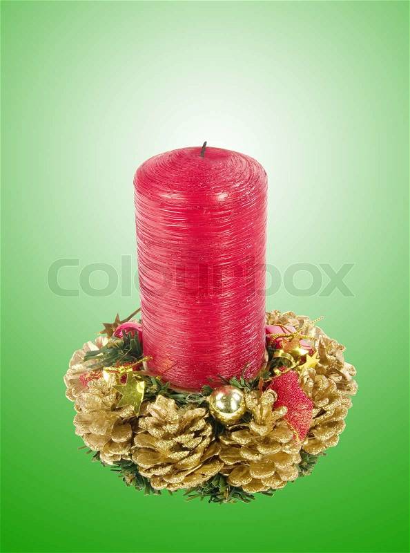 Christmas red candle isolated on green background, stock photo