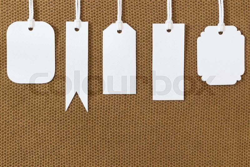 White blank tags label on fabric texture, stock photo