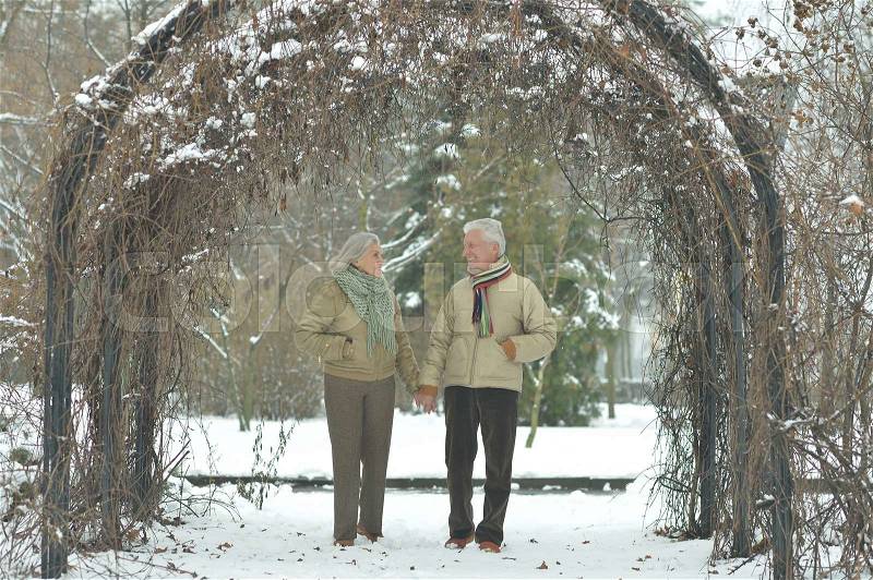 Happy senior couple at winter park outdoors, stock photo