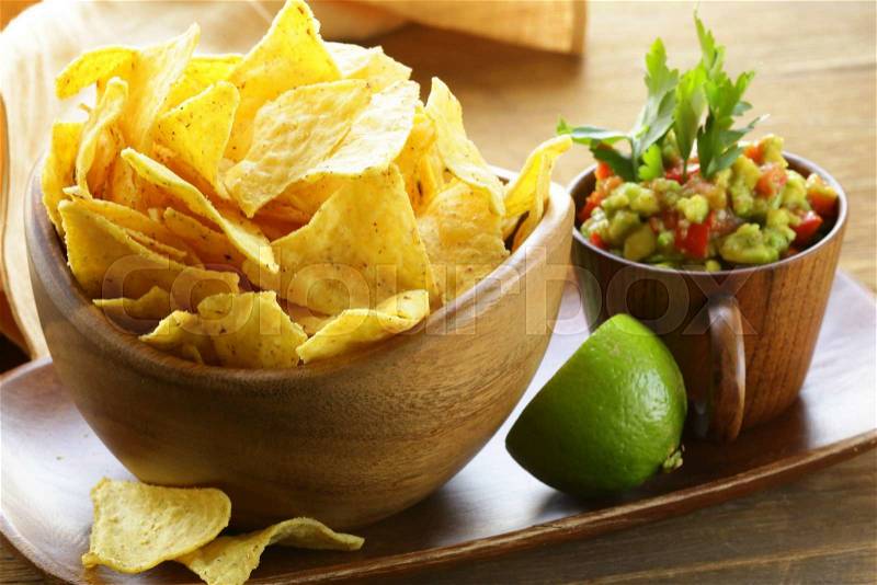 Corn tortilla chips in a wooden bowl, stock photo