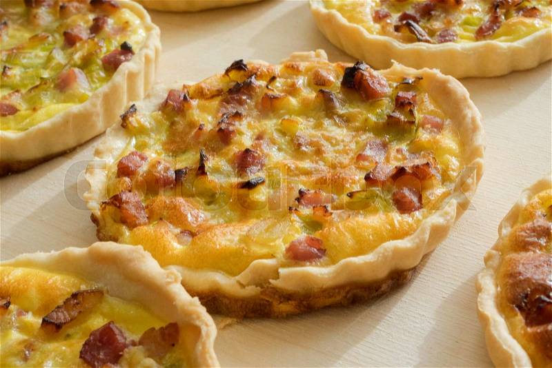 Home made French little quiche lorraine with partially broken base, stock photo