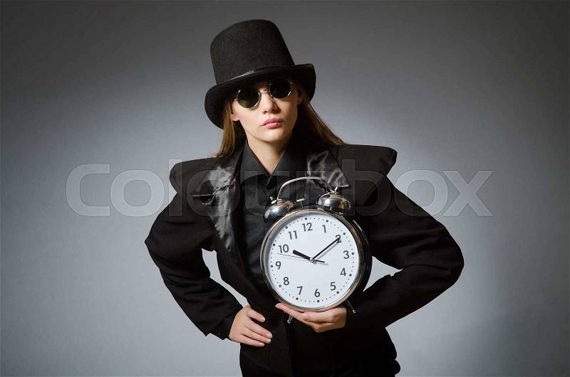 Woman with clock in business concept, stock photo
