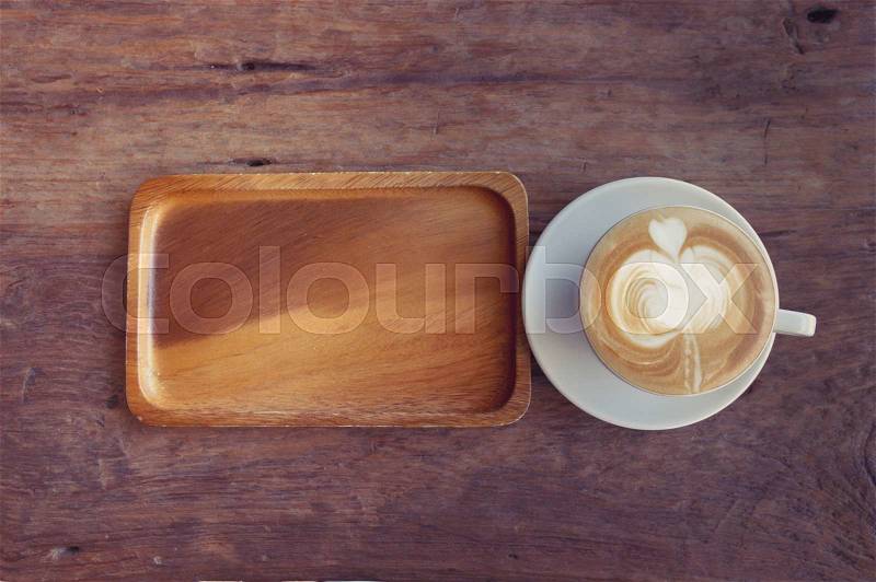 Close up cup of Coffee, latte on the wooden table - Vintage Filter Effect, stock photo