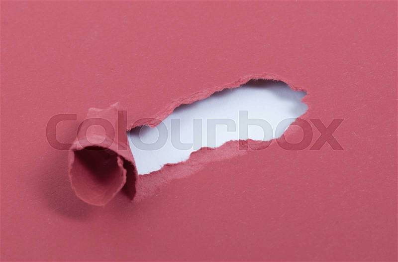 Hole in the paper with torn sides, stock photo