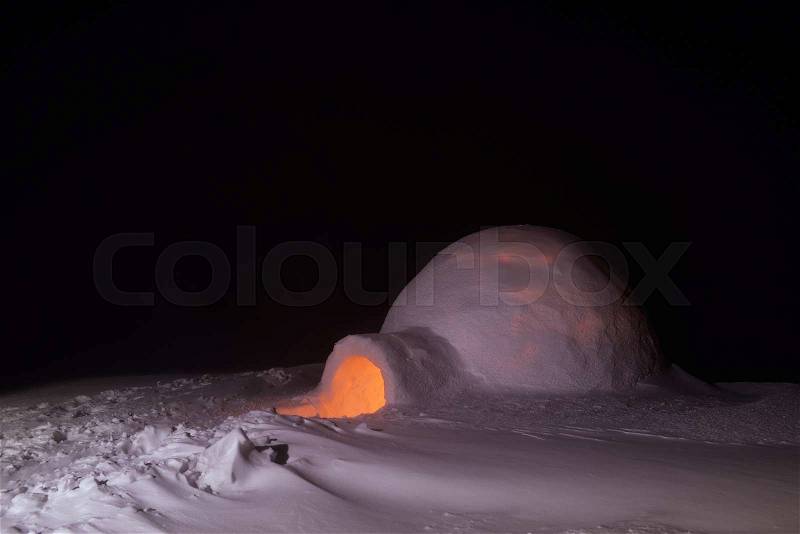 Night in mountains. Extreme snow house. Snow igloo, stock photo