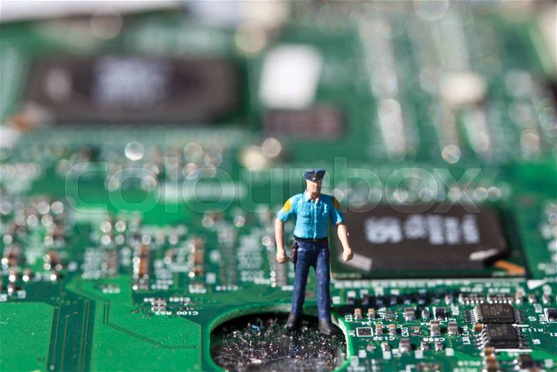 Macro picture of computer electronics with a policeman, stock photo
