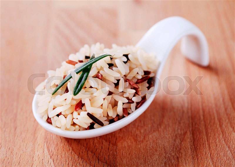 Mixed rice on a ceramic spoon - detail, stock photo