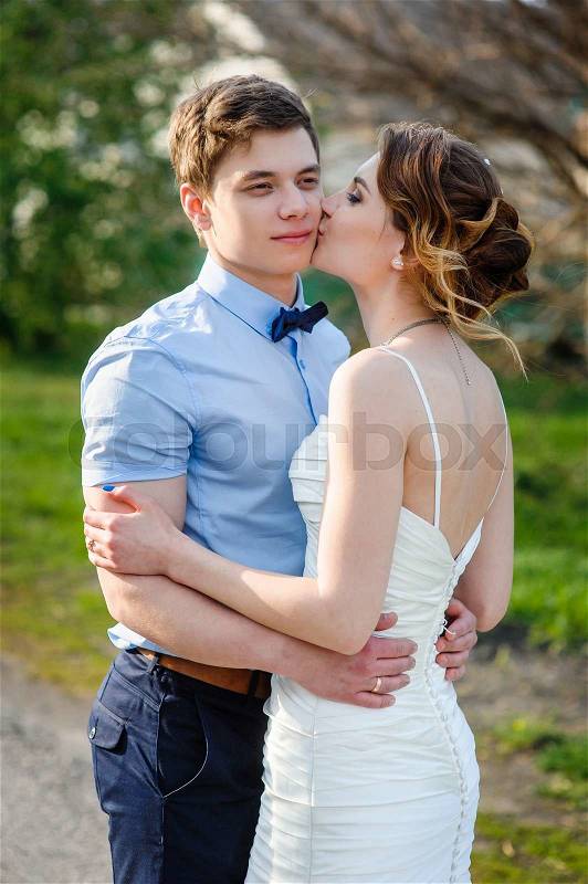 Bride and Groom at wedding Day walking Outdoors on spring in green park, stock photo