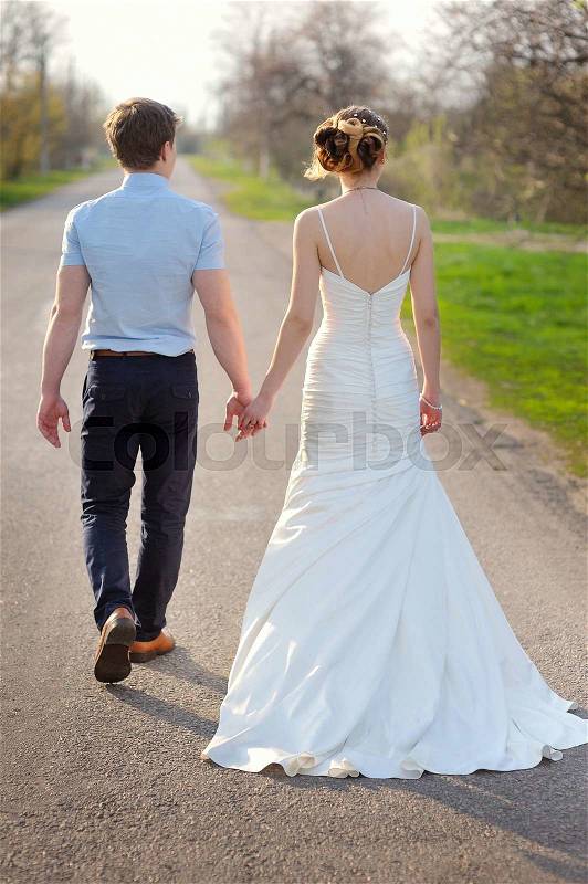 Young married couple walking on a countryside trail, stock photo