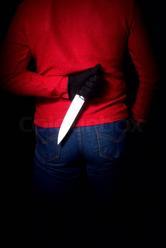 Criminal who hid the knife behind his back and waits for his moment, stock photo