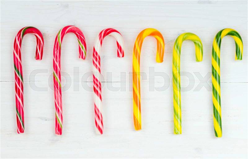 Christmas candy cane on the white wooden background, stock photo