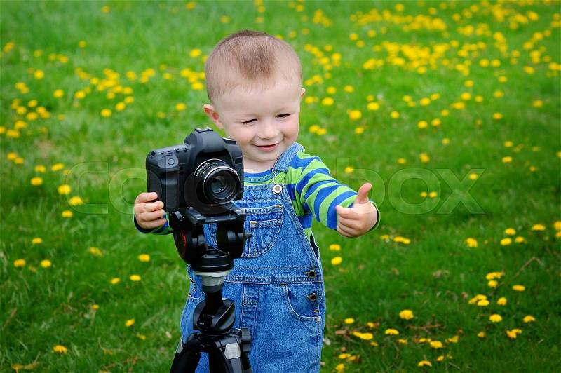 Little boy on the camera shoots, stock photo