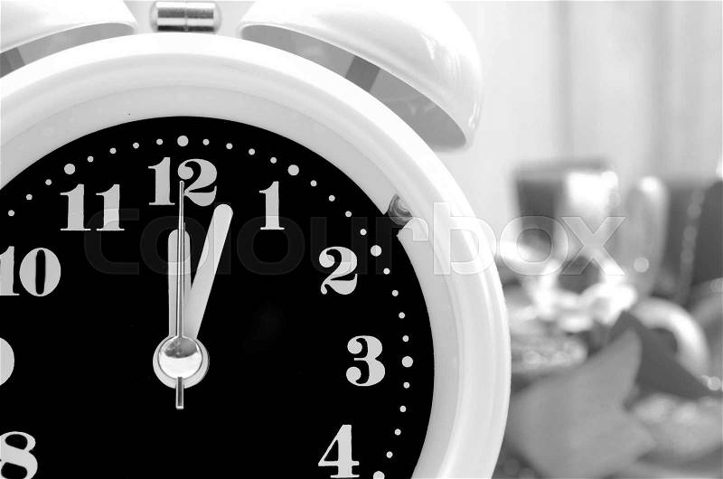 Alarm clock and blur a pile of gift box, black and white style for background, stock photo