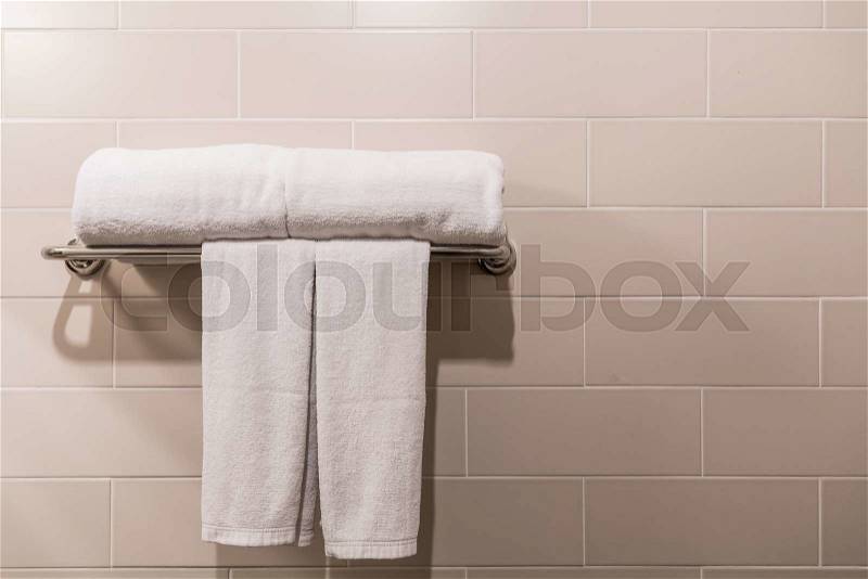 Bathroom Towel - white towel on a hanger prepared to use, stock photo