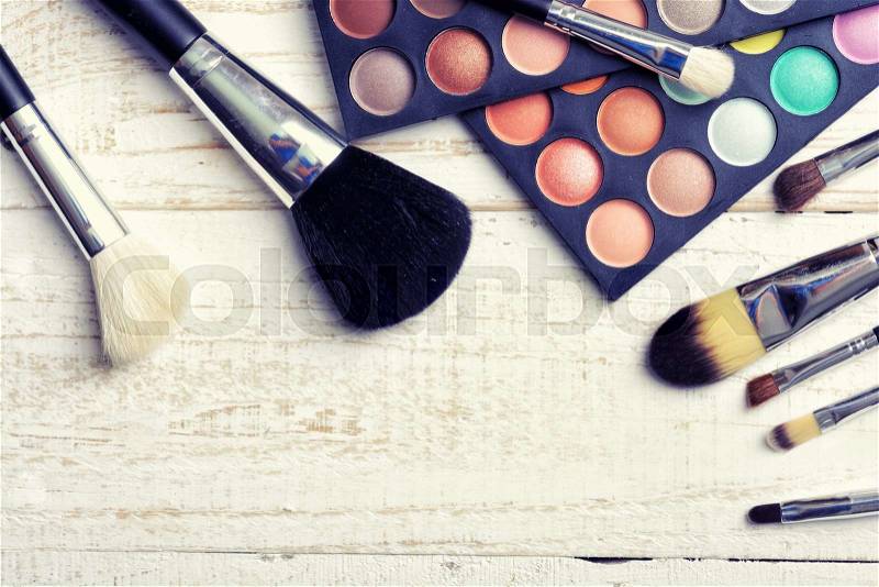Make up brush & palette on white wooden background, stock photo