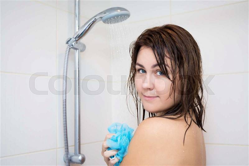 Hygiene concept - young beautiful woman washing her body in shower, stock photo