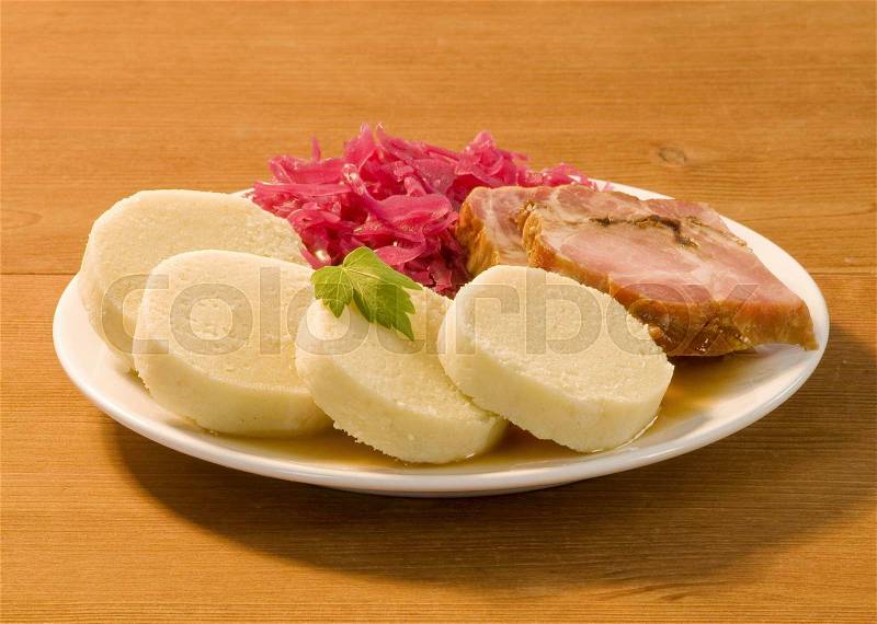 Roast pork, potato dumplings and red cabbage , stock photo