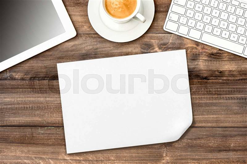 Workplace with coffee, paper, digital tablet pc. Office desk wooden background, stock photo