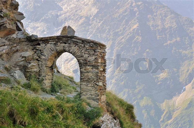 Stone arch on alpine hiking trail, stock photo