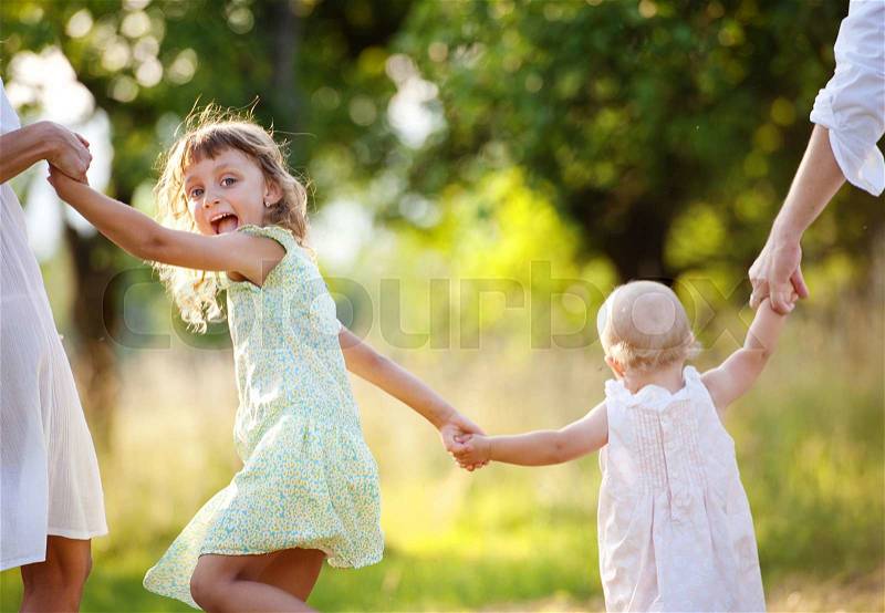Happy young family spending time outdoor on a summer day, stock photo