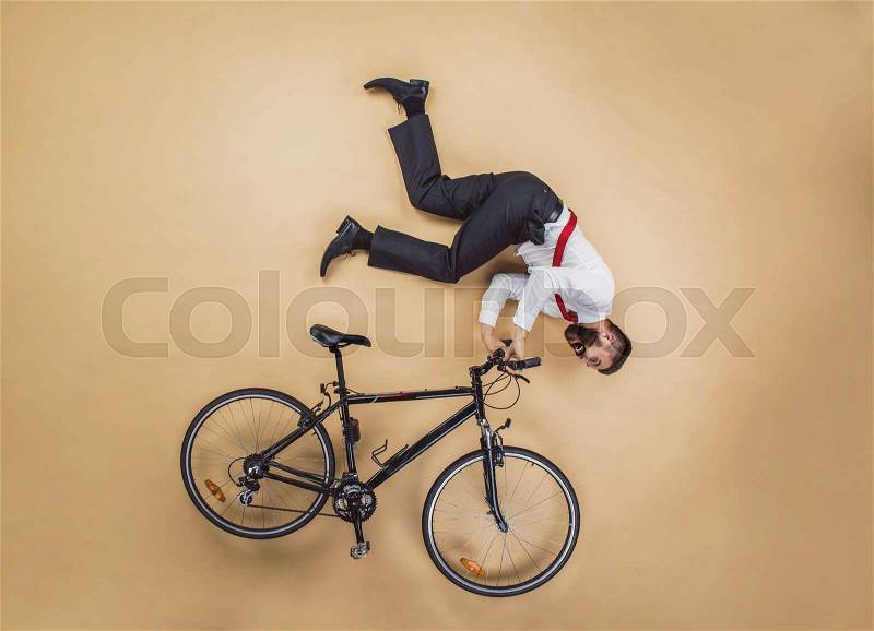 Handsome manager has an accident. Funny pose in studio, stock photo