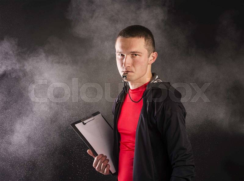Professional fitness coach isolated on black background, stock photo