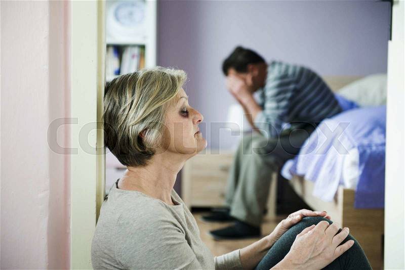 Mature woman with black eye is victim of domestic violence and abuse, stock photo
