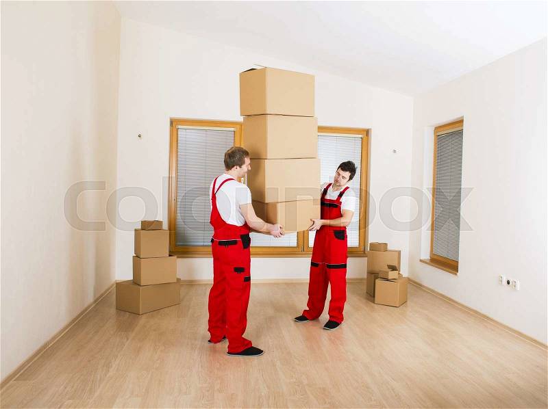 Movers in new house with lot of boxes, stock photo