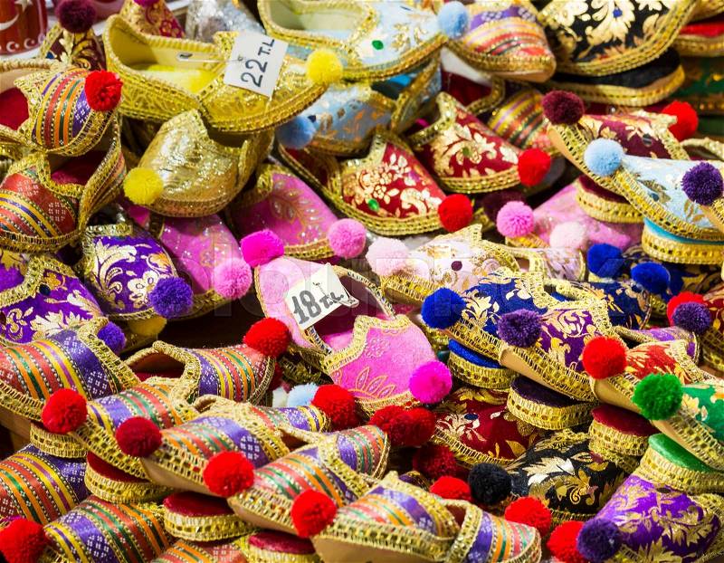 Eastern bazaar - handmade shoes. Image of selling point at Istanbul market with large selection of traditional arabic handmade ornate shoes, stock photo