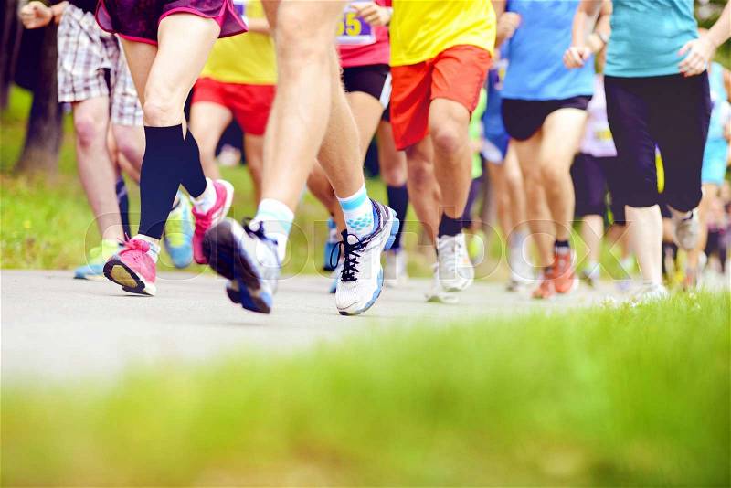 Group of unidentified marathon racers running, detail on legs, stock photo